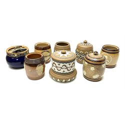 A group of Doulton Lambeth and Royal Doulton tobacco jars, most with relief moulded foliate decoration, (four examples lacking covers), largest example H15cm. 