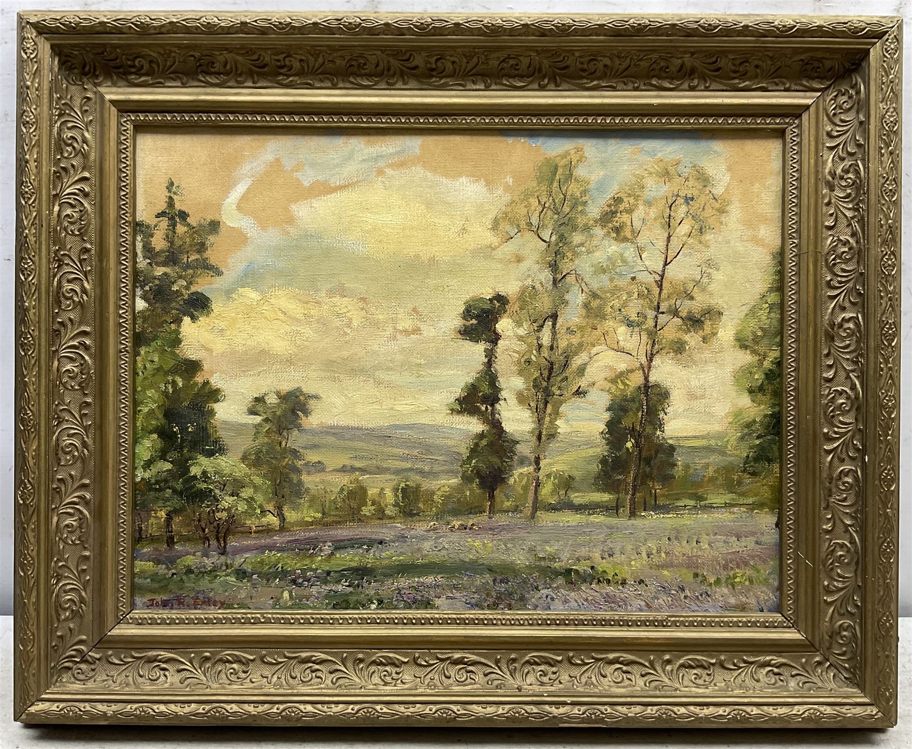 John Robert Exley (Lancashire 1890-1979): The Bluebell Meadow, oil on canvas board signed 29cm x 39cm; Village Landscape, oil on canvas laid on to board unsigned, attributed by the artist's widow on label verso 17cm x 26cm (2)