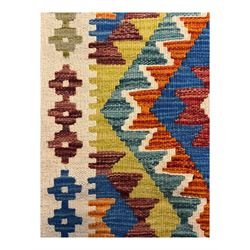 Kilim runner rug, central field decorated with four stacked geometric medallions in a multicoloured zigzag design, bordered by a series of small geometric motifs, fringed edges at both ends