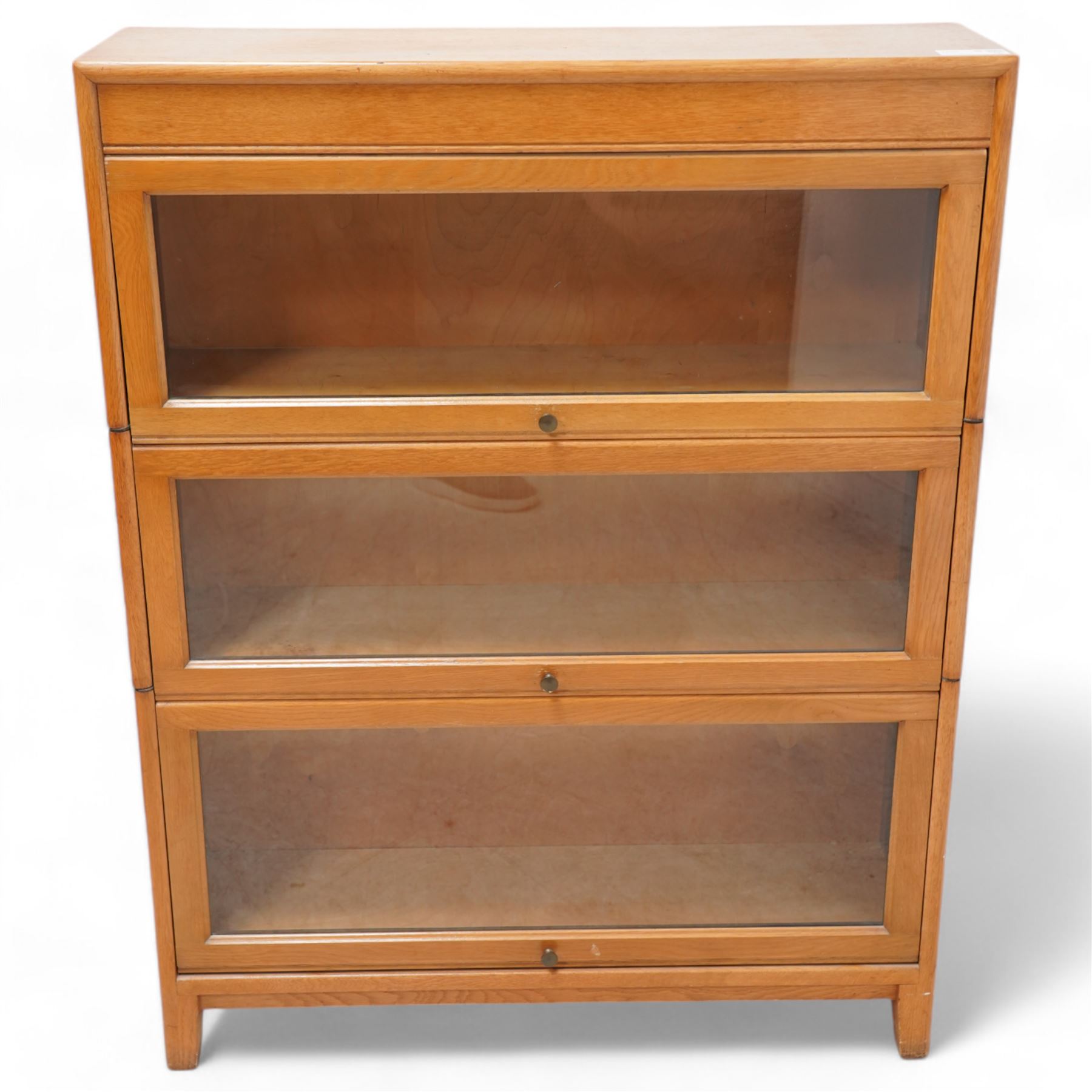 Angus Gunn - early 20th century light oak three sectional stacking bookcase, enclosed by hinged and sliding glazed doors