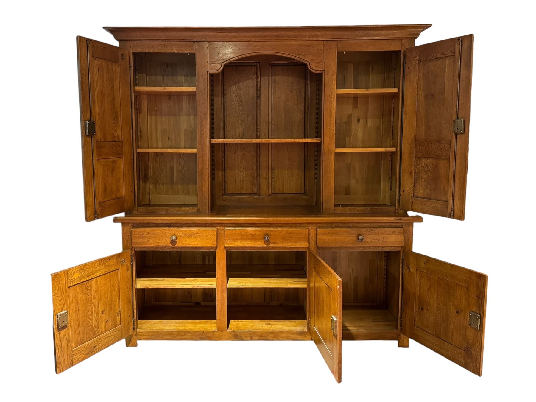 Large 20th century oak dresser, projecting cornice over open arched central section with two shelves, flanked by two panelled cupboards with two shelves, lower section with three drawers above three cupboards, on stile supports 