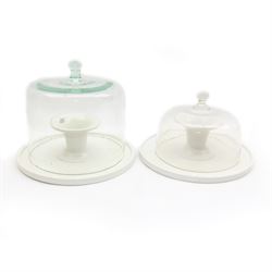 Two French glass cloches, with footed ceramic bases marked 'Geo.S.Elliott & Son Ltd