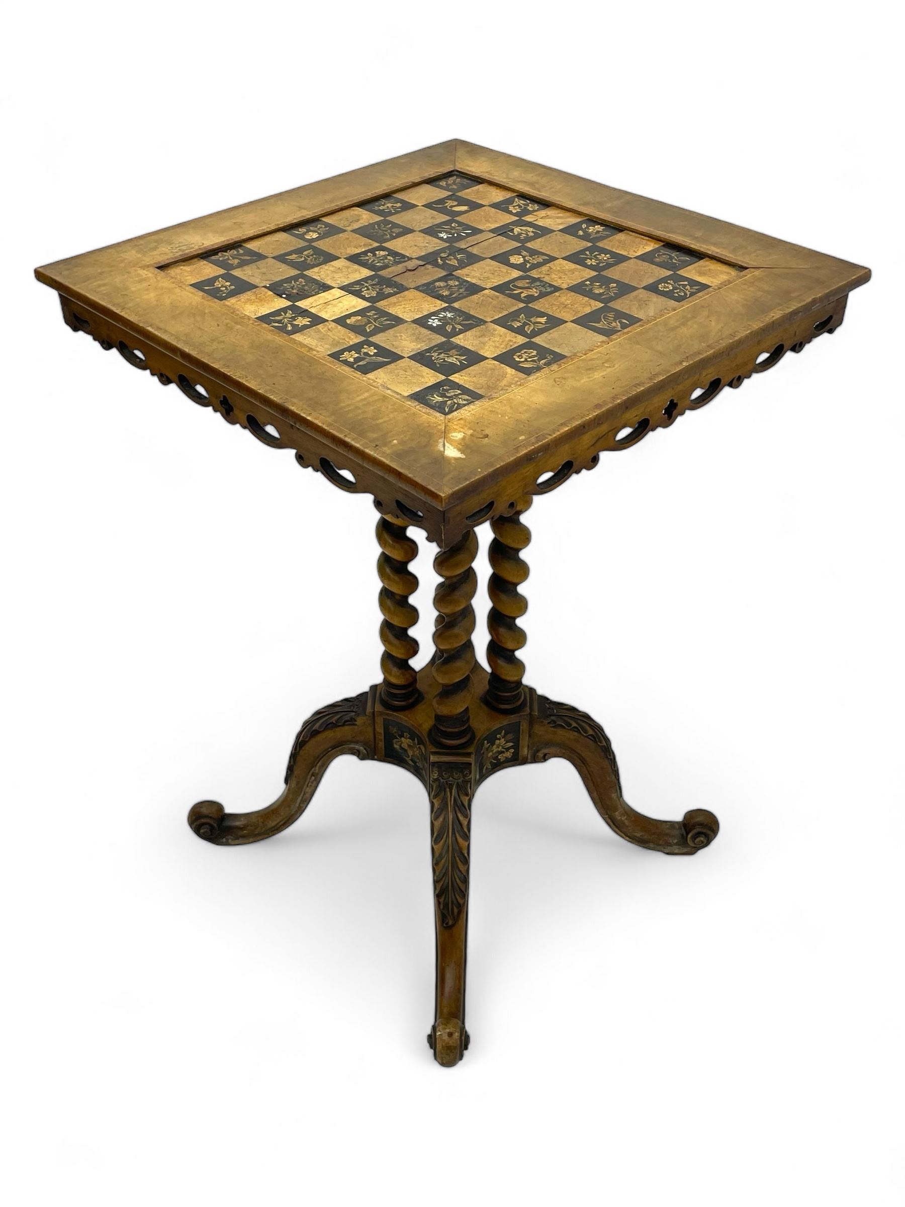 Late 19th century walnut games table, the square top with sunken inlaid chessboard decorated with inlaid floral bouquets, shaped and pierced frieze rails, on quadruple spiral turned pillars, concaved square platform inlaid with flowers, on acanthus leaf carved splayed supports with scrolled terminals 