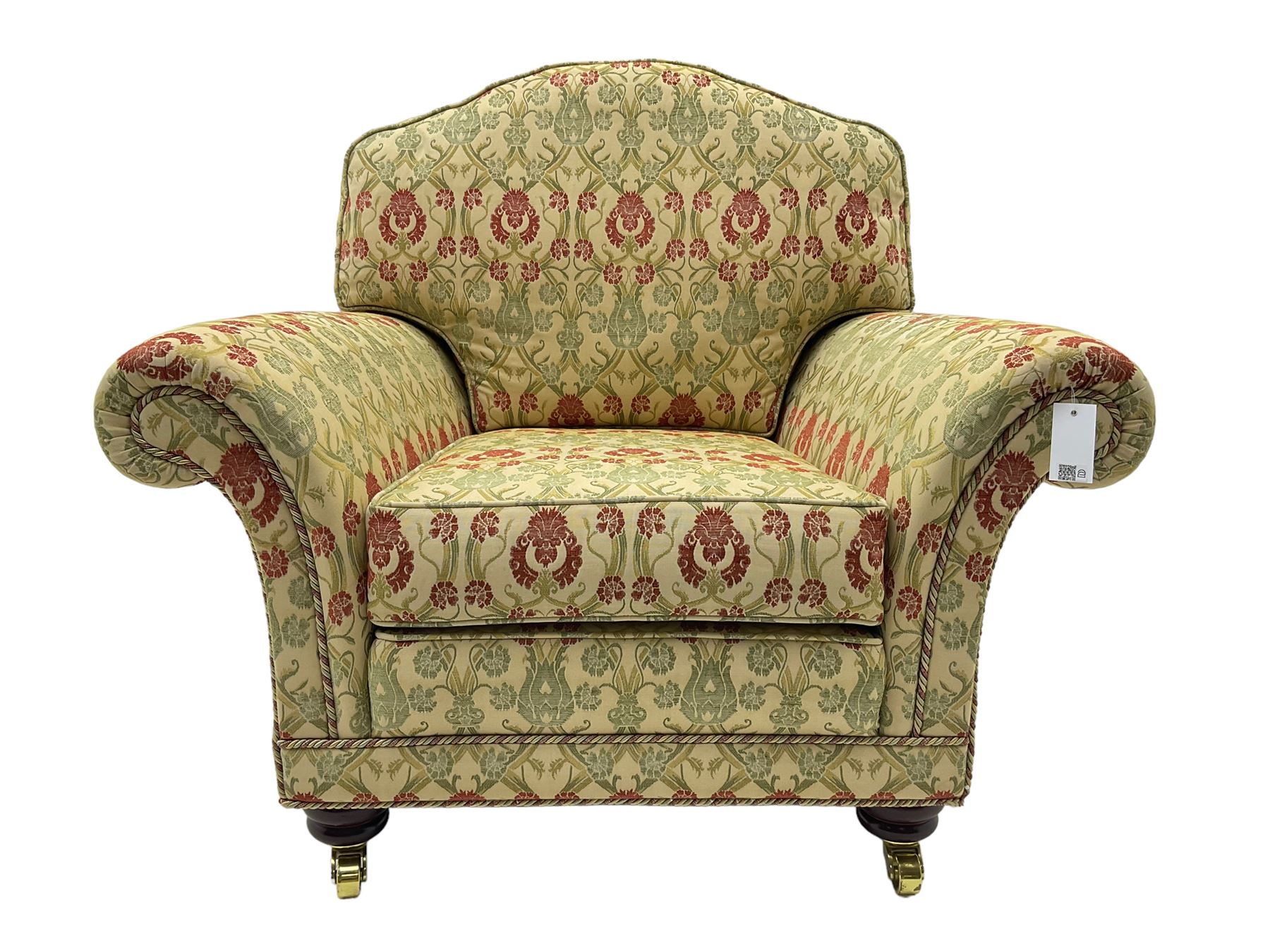 Traditional design two seat sofa, high back with scrolled arms, upholstered in beige fabric with red and green damask motifs, on castor supports (L178cm, D100cm, H89cm); matching armchair (L109cm, D89cm, H89cm)