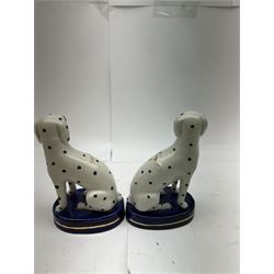 Pair of Staffordshire figures modelled as chained Dalmatians seated upon cobalt blue oval bases, H13cm, together with a Staffordshire pastille burner modelled as a castle, H12cm, a pair of 19th century Derby potpourri pots (lacking covers), and an 18th century blue and white tea bowl 