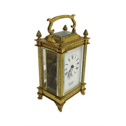 Early 20th century French carriage clock - 8-day timepiece movement in a decorative case with bevelled glass panels, white enamel dial with Roman numerals, minute markers and steel hands, retailed by Smith and Son, Scarborough, original lever platform escapement, with key.