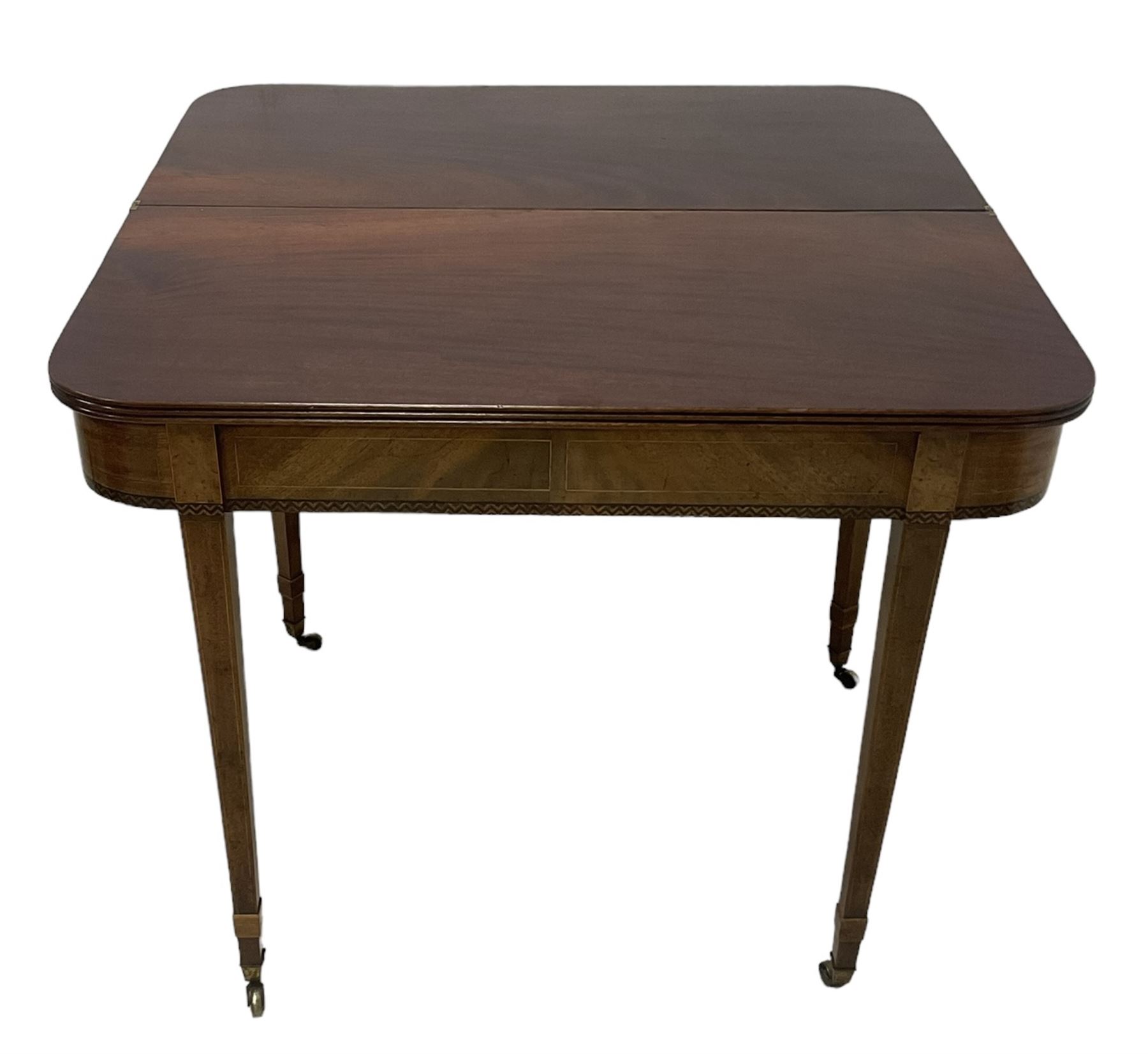 19th century mahogany tea table, fold-over top with reeded edge over inlaid frieze, on double gate-leg action square tapering supports, with brass castors