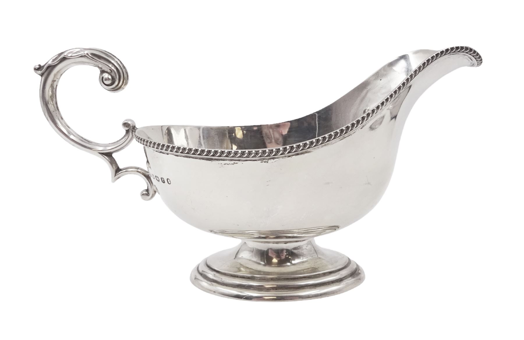 1930s silver sauce boat, of typical form, with oblique gadrooned rim and acanthus capped flying C scroll handle, by William Hutton & Sons Ltd, Sheffield 1934, H11cm