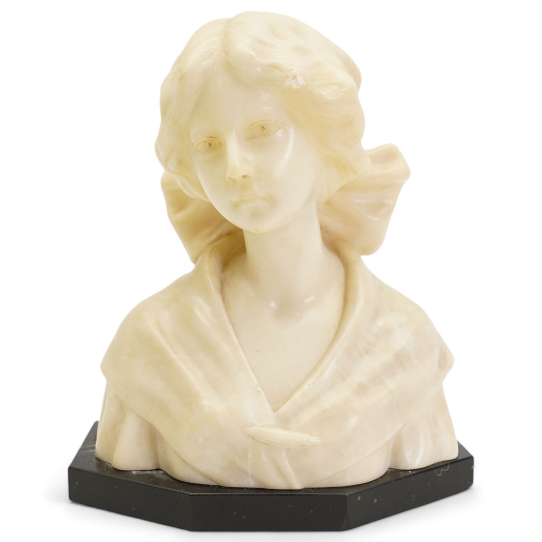 Early 20th century alabaster of a young girl, wearing a ribbon in her hair, on a black marble base, H19.5cm and another carved female bust on an ebonised base, H20.5cm (2)