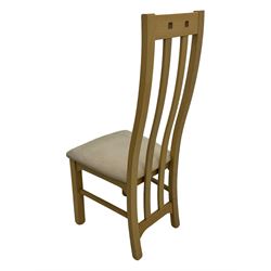 Contemporary set of four oak dining chairs, tall slatted curved backs with square cutouts to the top, upholstered seats in light fabric, on square front supports