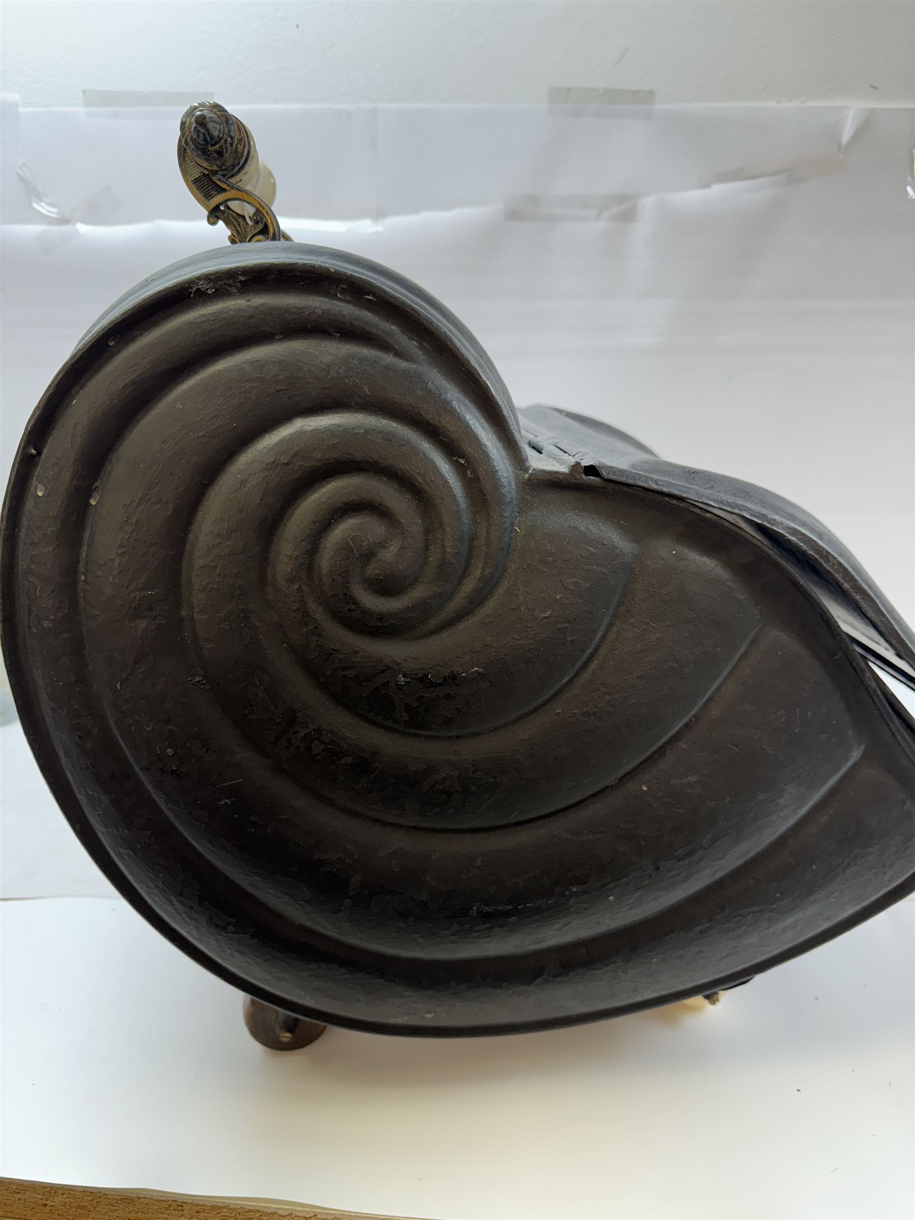 Victorian black matte metal coal scuttle, in the form of a nautilus shell, with ceramic wheels and handle, H47cm