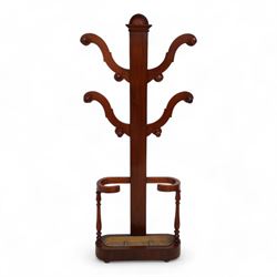 Victorian mahogany hall stand, central rectangular pillar supporting four projecting branches with turned hat and coat hooks, lower stick and umbrella stand on turned supports with metal drip tray, skirted base on compressed bun feet 