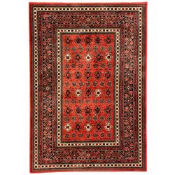 Persian design red ground rug, the field decorated with geometric motifs, repeating multiple band border 