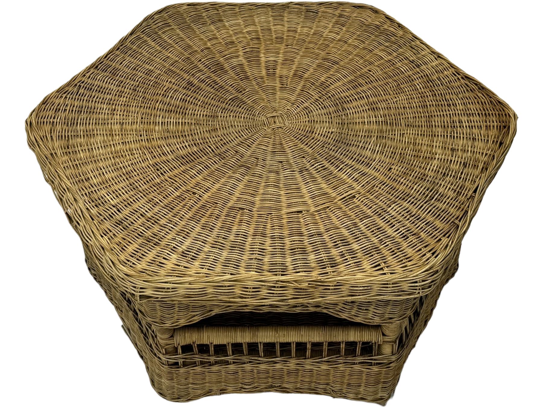 Mid-20th century hexagonal wicker coffee table, featuring woven top with pattern that radiates from the centre, lower shelf for additional storage, supported by interwoven wicker legs