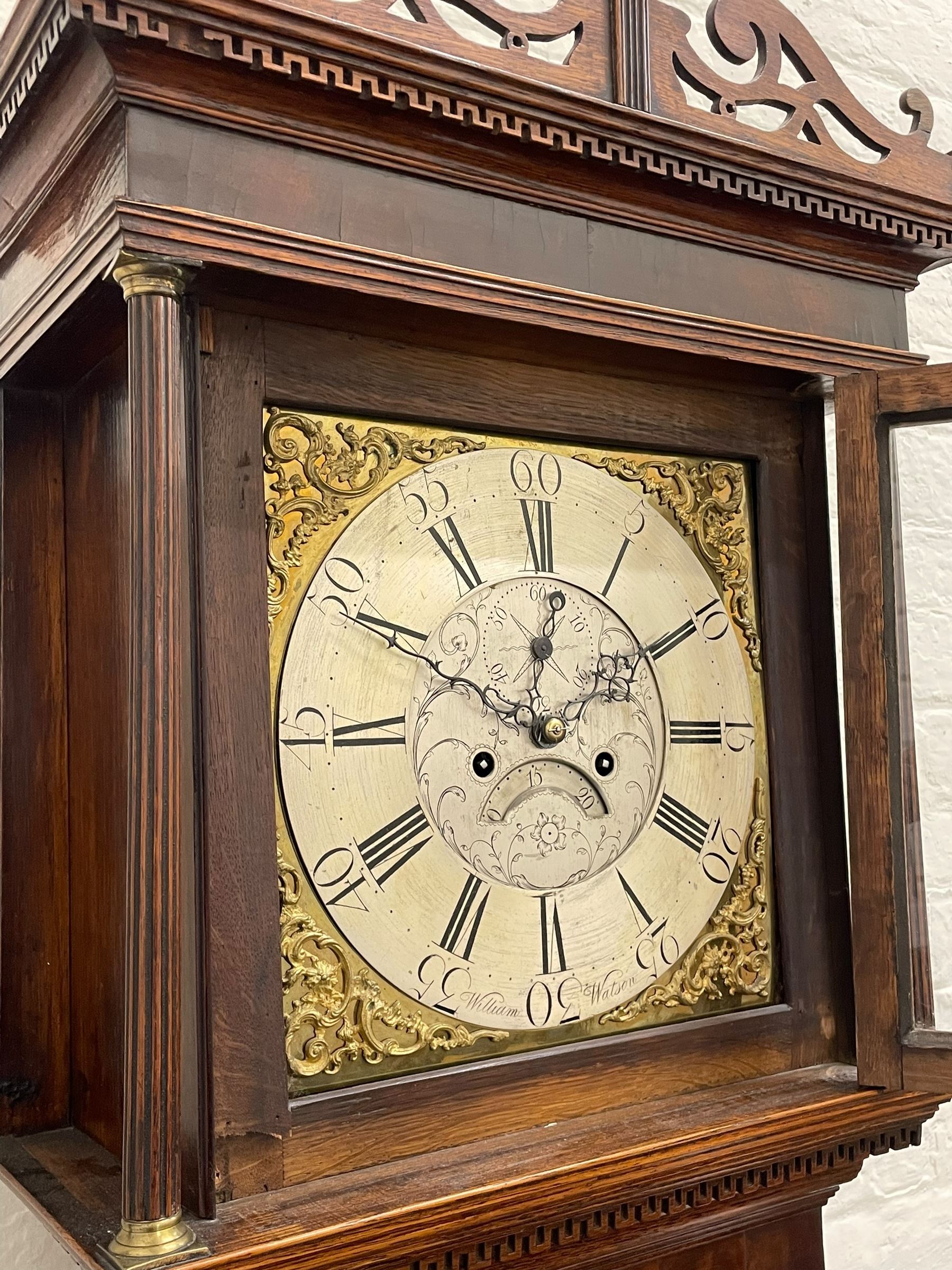 William Watson of  Blackburn (Lancs)  - late 18th century 8-day oak and mahogany cross banded longcase clock, with a flat top and open fretwork above, deep cornice with dogtooth moulding and frieze beneath, square hood door flanked by reeded pilasters with brass capitals, trunk with  reeded quarter columns, long trunk door with concave corners on a plinth with canted corners on bracket feet, brass dial with cast brass spandrels, broad silvered chapter ring with Roman numerals and five-minute Arabic's, a profusely engraved and silvered dial centre with seconds dial, matching steel hands and calendar aperture, hourly rack striking movement with a recoil anchor escapement. With weights, pendulum and key. 
William Watson of Northgate, Blackburn, is recorded as working c1770-1814 . As with this clock he frequently signed some of his clocks without a placename.