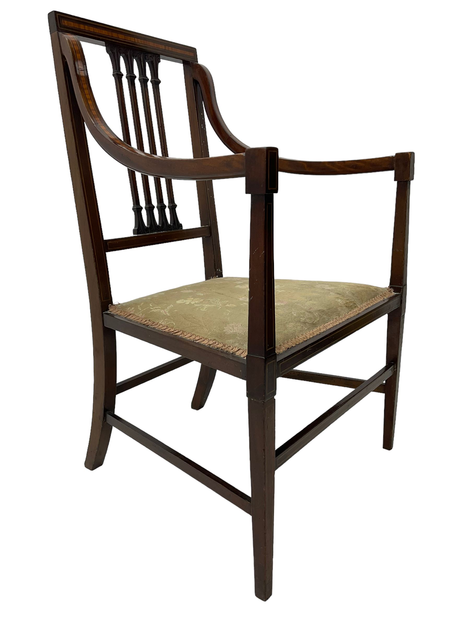 Edwardian satinwood inlaid mahogany elbow chair, the bar back over four vertical rails with foliate and scroll carved decoration, curved and down-swept arms, on square tapering supports united by stretchers 