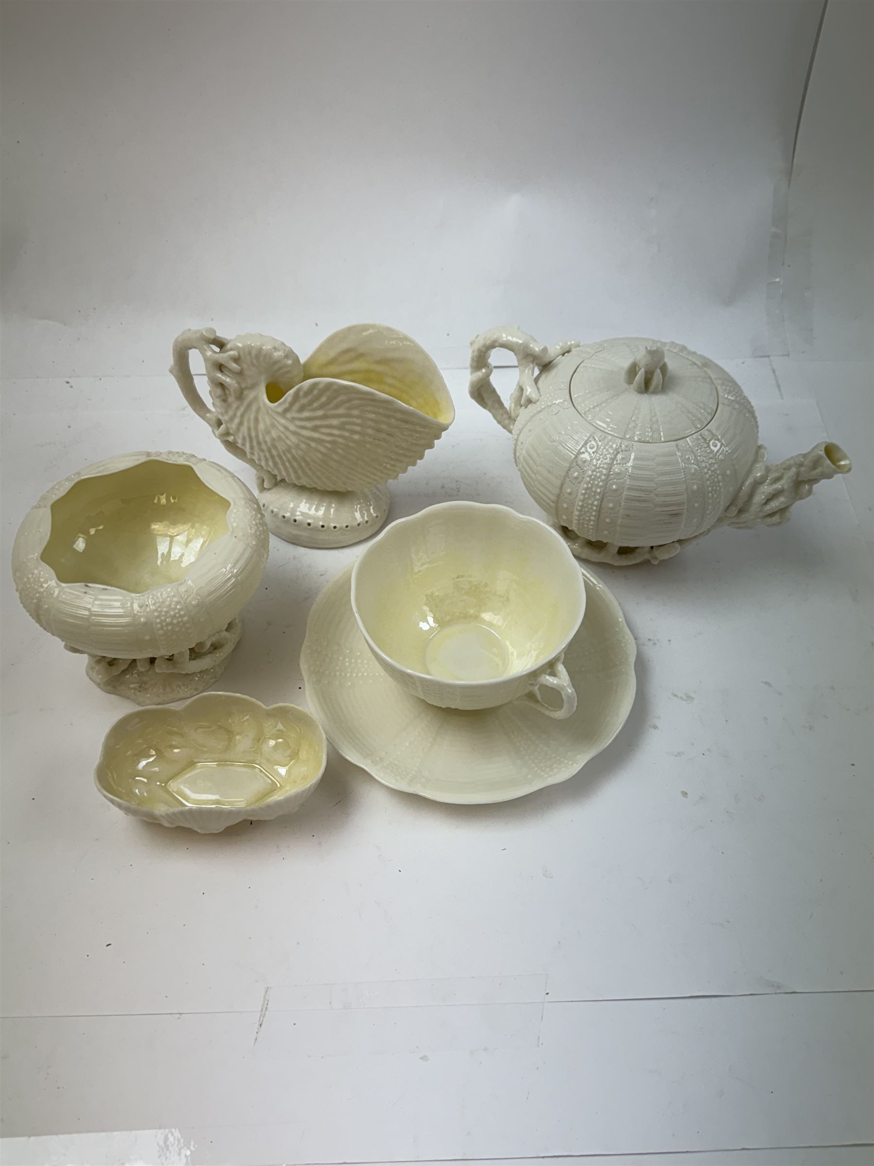 Belleek Sea Urchin teapot and sugar basin, together with Belleek Nautilus jug, small dish, teacup and saucer