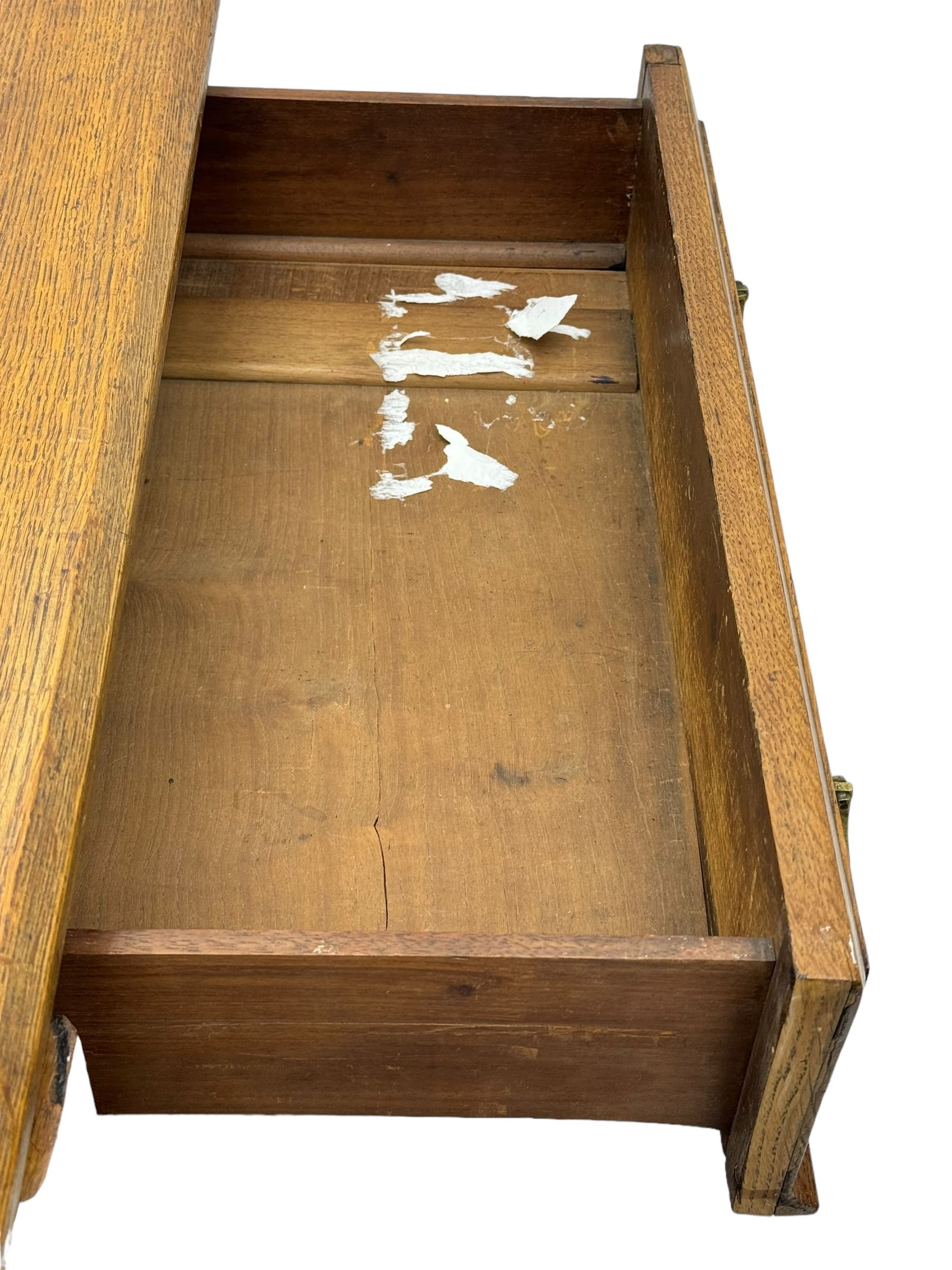 Late Victorian oak twin pedestal desk, chamfered rectangular top over three convex front edge drawers and two panelled cupboards, flanked by carved supports with roundels and diamond motif, on bracketed plinth base