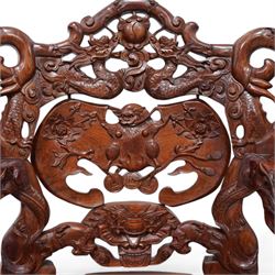 Pair of Japanese carved hardwood throne chairs, pierced and dragon carved cresting over pierced back panel carved with bat, extending dragon carved arms over panelled seat, the seat rails pierced and carved with trailing branches and foliate motifs, on cabriole supports 