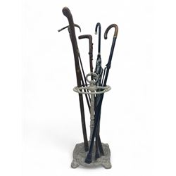 Victorian design cast iron umbrella stand, ornate stem on shell C-scroll base; together wi...