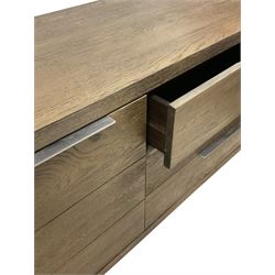 Contemporary dark oak finish sideboard, three central drawers flanked by single cupboards, on angular black finish metal supports 