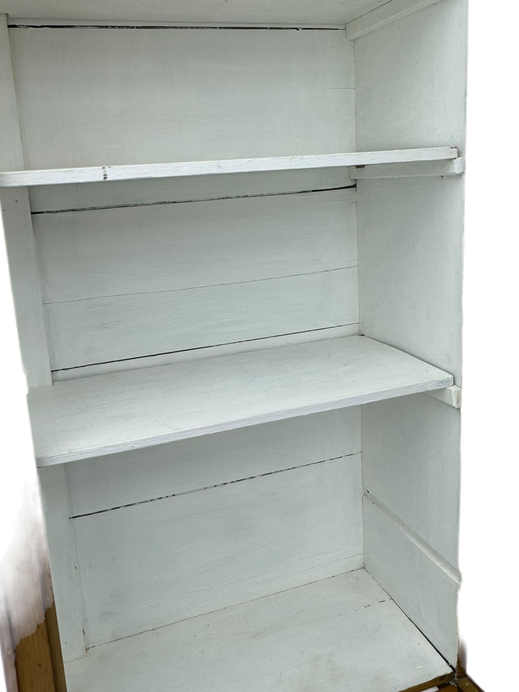 Georgian stripped pine bookcase display cabinet, plain moulded cornice over two glass-panel doors with multiple panes, enclosing white painted interior with three shelves, raised on square supports