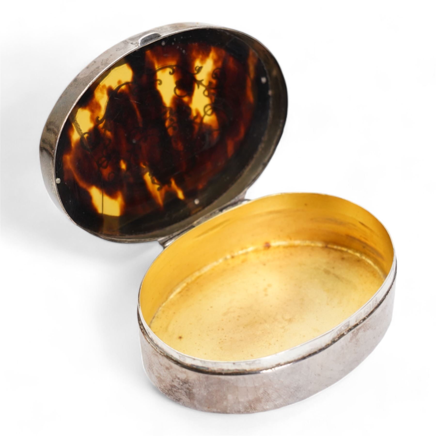 Edwardian silver and tortoiseshell oval box with pique decoration W6cm Birmingham 1909, Maker Levi & Salaman, engine turned silver cigarette box W16cm London 1975 and a silver coaster D9.5cm Sheffield 2008 (3)