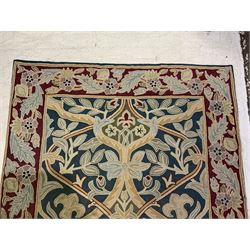 Caucasian design crewelwork hanging, the field decorated with a stylised tree of life motifs with surrounding leafage, enclosed by a crimson ground border with foliate designs