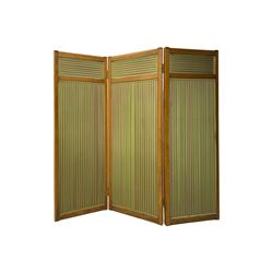 Edwardian oak and fabric folding screen, featuring three panels with oak frames, one side covered in green striped fabric with decorative trim, the reverse side in pink moiré effect fabric, connected by brass hinges