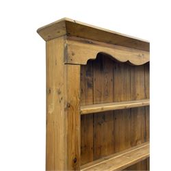 Waxed pine 'chicken coop' or 'hutch' dresser, projecting cornice over shaped frieze and three tier plate rack, the stepped waterfall lower section fitted with two slatted chicken coops, on sledge feet 