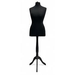 Contemporary black mannequin, featuring a fabric-covered torso supported by a chrome pole ...