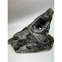 Inuit soapstone carving, of a hunter and a polar bear, circa 1960, H19cm 