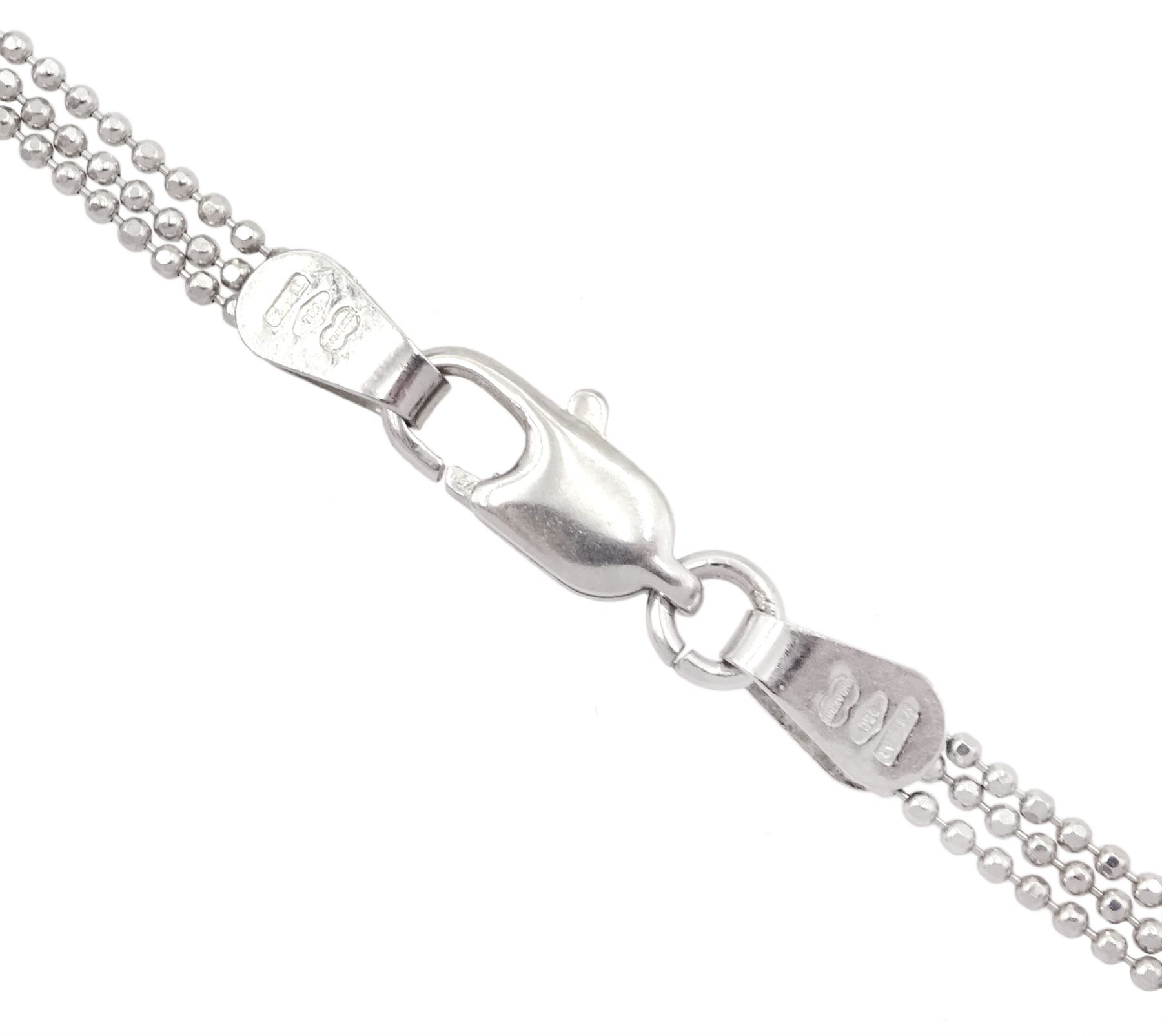 18ct white gold three strand bead necklace, stamped 750