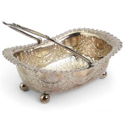  Victorian silver rectangular sugar basket with swing handle decorated with garlands and foliage on ball feet W15cm Sheffield 1891 Maker James Dixon & Son and a silver cream jug and sugar bowl Chester 1919 