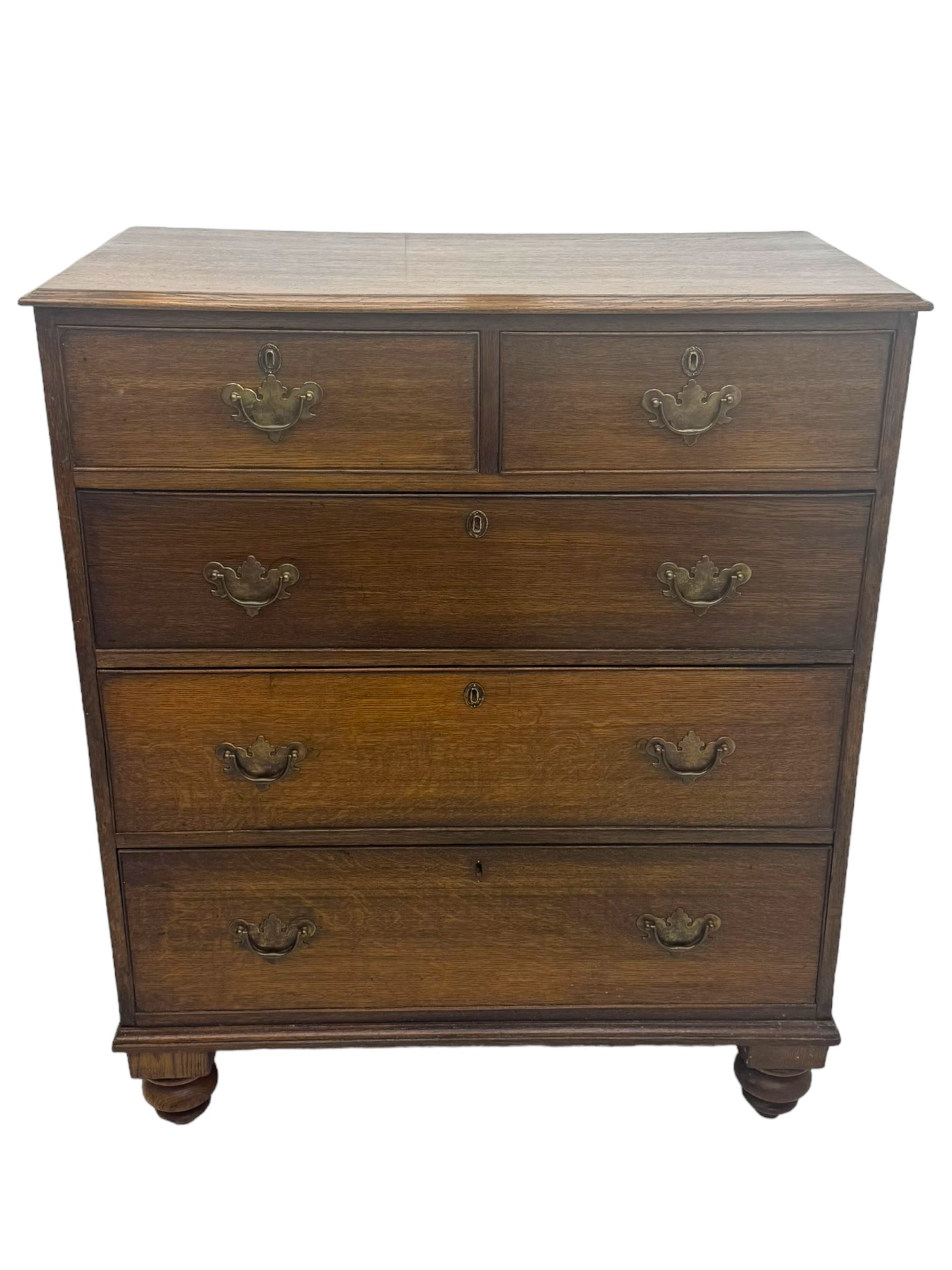 George III oak chest, rectangular top with moulded edge over two short and three long graduated drawers, each with brass escutcheons and shaped backplate handles, on turned bun supports 