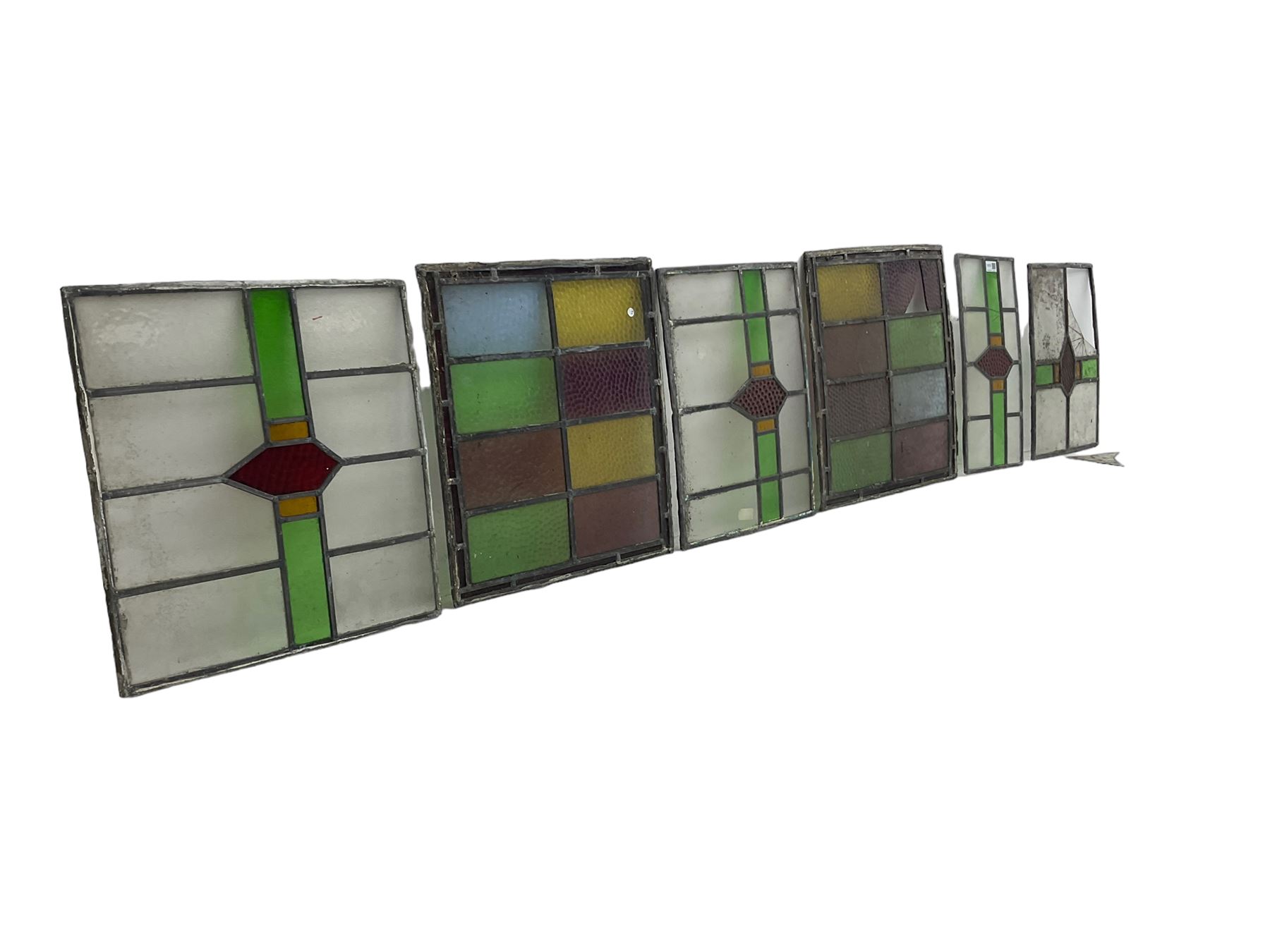 Six leaded stained glass window panes, largest measuring - 46cm x 41cm