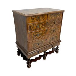 18th century inlaid walnut chest on stand, ovolo-moulded rectangular top inlaid with ebony panels each decorated with scrolling foliage, flower heads and birds, fitted with two short over three long drawers, the drawer fronts decorated with ebony panels enclosing curled leaf inlays, the base fitted with single drawer on turned supports united by waved stretchers, on turned bun feet 