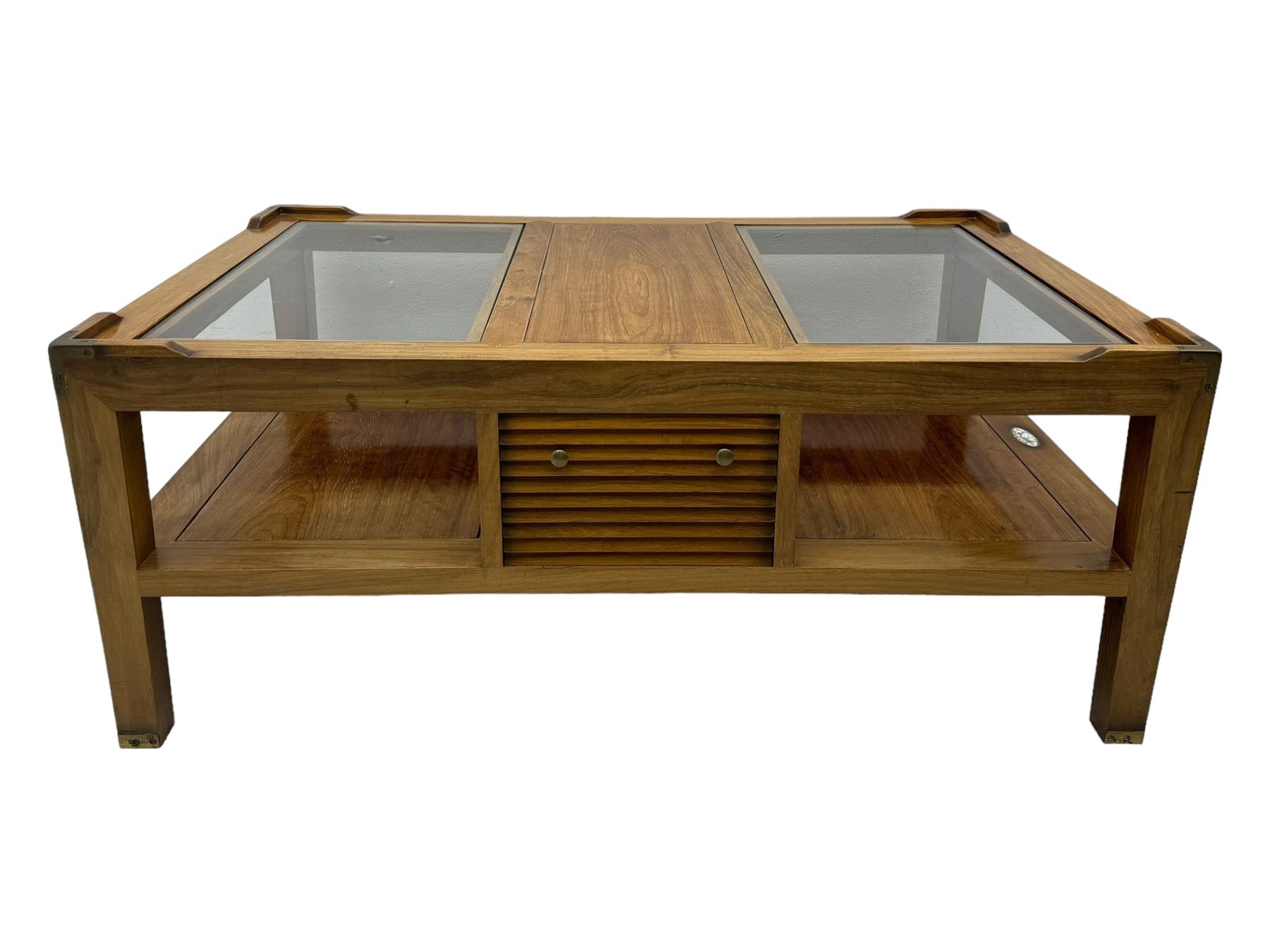 Starbay Tobago cherry wood coffee table, rectangular top with two inset glass panels, central drawer with louvred front and brass handles, flanked by open shelving, raised on square supports with metal corner brackets