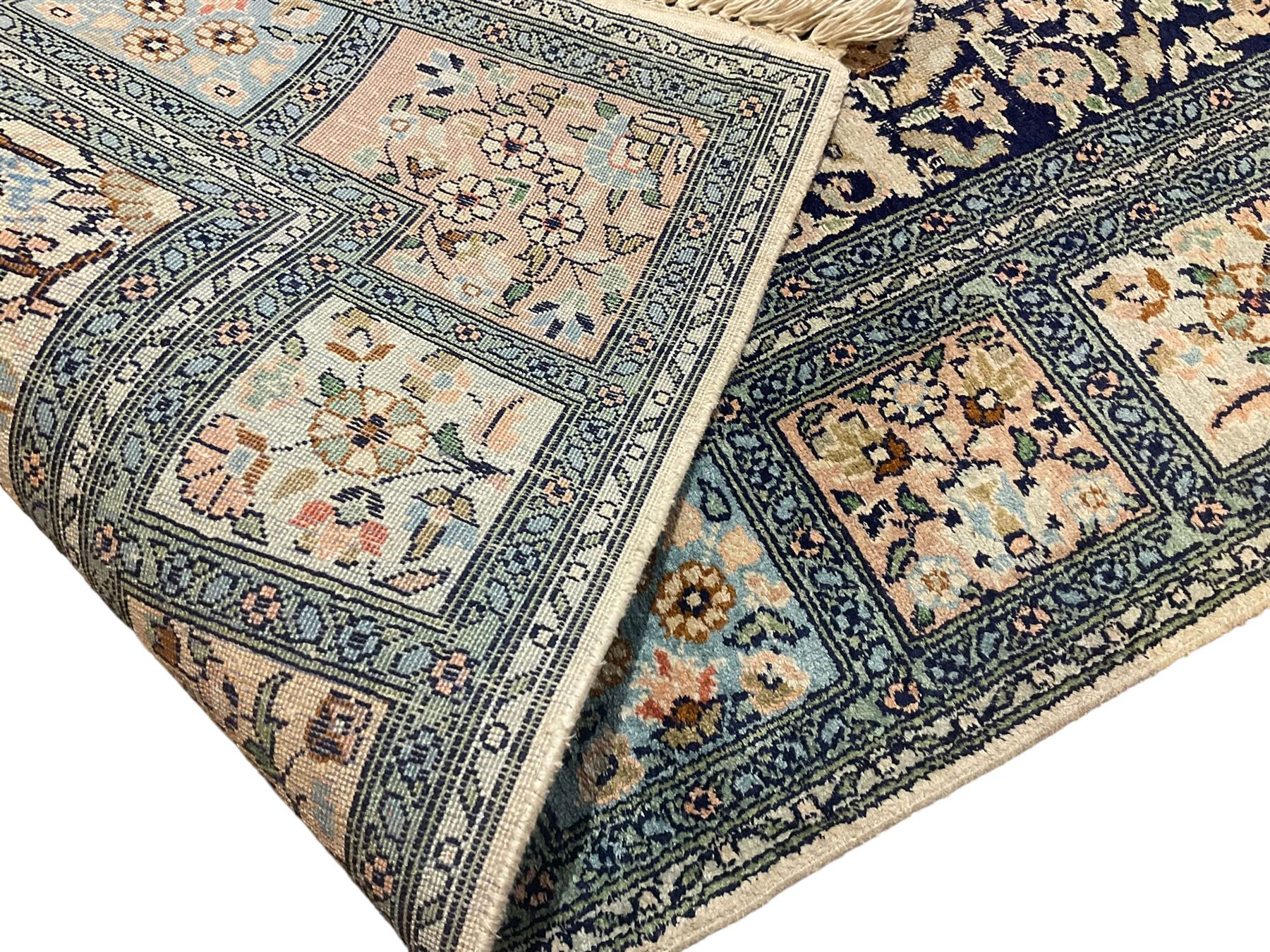 Fine Persian Kashmir ivory and pale indigo ground runner rug, the field decorated with sixteen rectangular panels depicting Mirab motifs and other traditional carpet designs, the border with repeating square panels of floral bouquets and foliate patterns