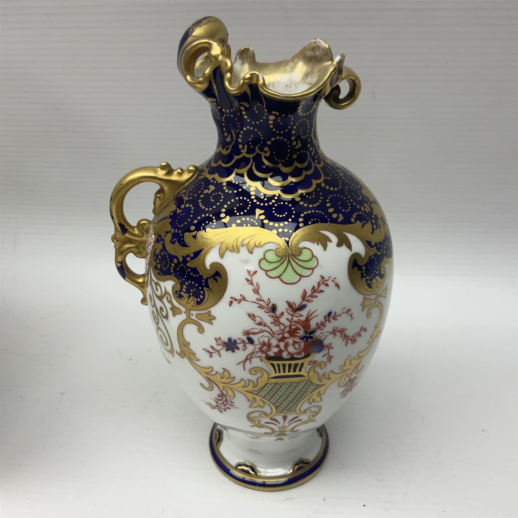 Royal Crown Derby Imari pattern single handled vase, circa 1897, together with two 1126 Imari pattern plates and a saucers, 2451 imari pattern plate and 6299 Imari pattern miniature jar, all with printed marks beneath 