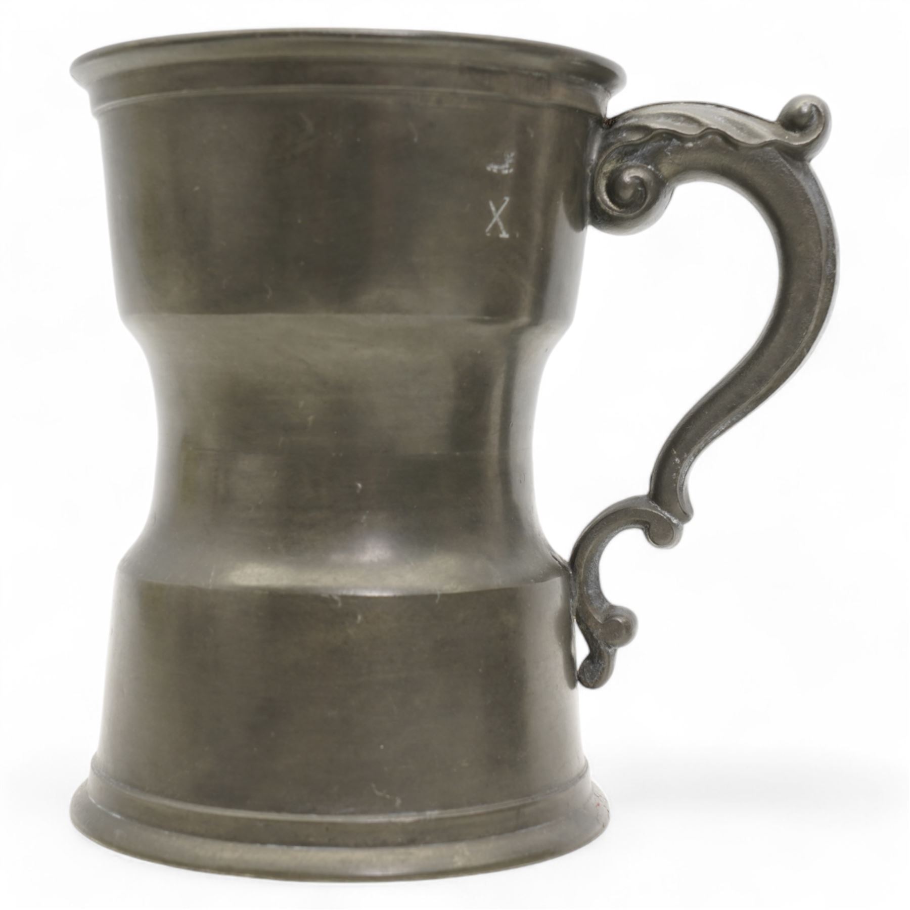 18th century pewter tankard, circa 1770, with scroll handle and acanthus leaf thumbpiece, touch marks and crowned X, H13cm, together with a Victorian 1/2 pint pewter measure, touch marks, weights and measures inspector verification mark (2)