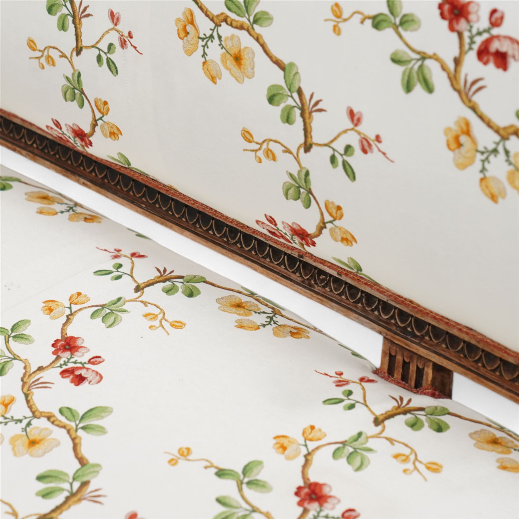 Late 19th century Swedish beech-framed settee, upholstered in cream fabric with trailing foliate pattern decorated with flowers, carved and moulded frame, scroll carved arm terminals on shaped moulded arm supports, on turned and fluted feet