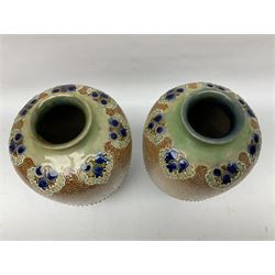 Pair of Royal Doulton Lambeth stoneware baluster vases, decorated in light relief with foliage, impressed mark beneath, H23cm