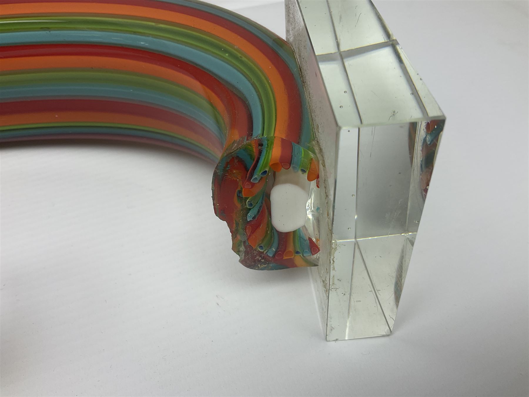 Three art glass sculpture, coiled form with multicolour stranded, upon clear glass plinth, unsigned, largest H27cm