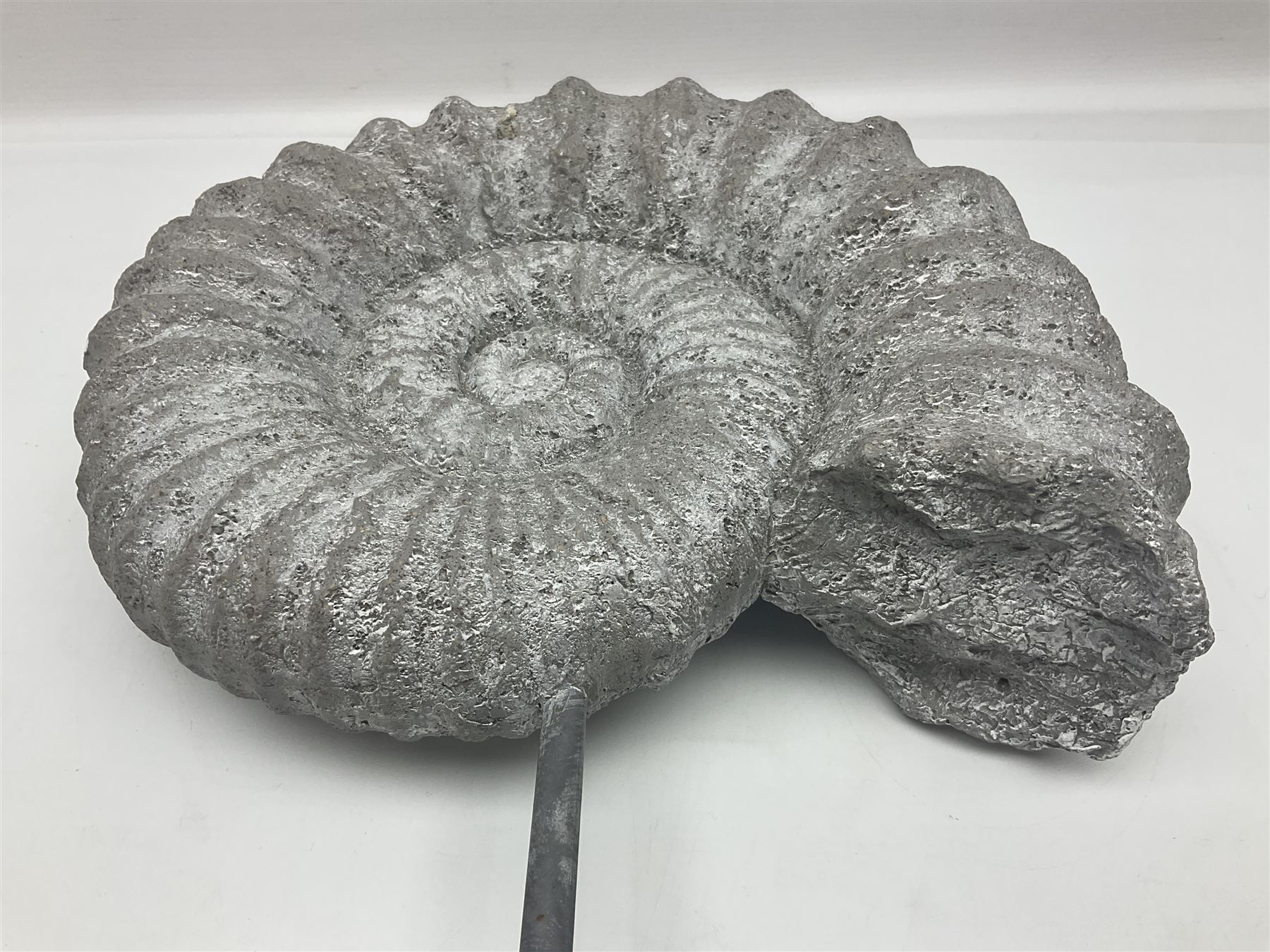 Composite Ammonite, raised on a wooden stepped plinth, H36cm