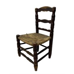 19th century painted elm primitive fire side chair, ladder back over rush seat, on turned supports united by turned stretchers 