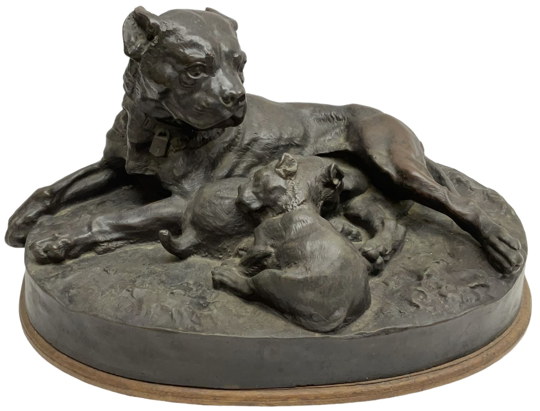 After W. Wolfe; bronze cast figural group depicting bullmastiff feeding puppies, signed with impressed mark to the front, on oval wooden base, H20cm