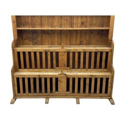 Waxed pine 'chicken coop' or 'hutch' dresser, projecting cornice over shaped frieze and three tier plate rack, the stepped waterfall lower section fitted with two slatted chicken coops, on sledge feet 