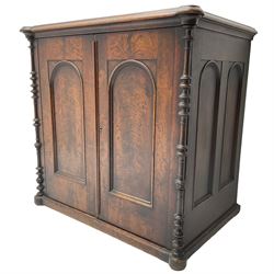 Victorian lacquered mahogany cupboard, fitted with two arch panelled doors enclosing two shelves, flanked by split turned uprights