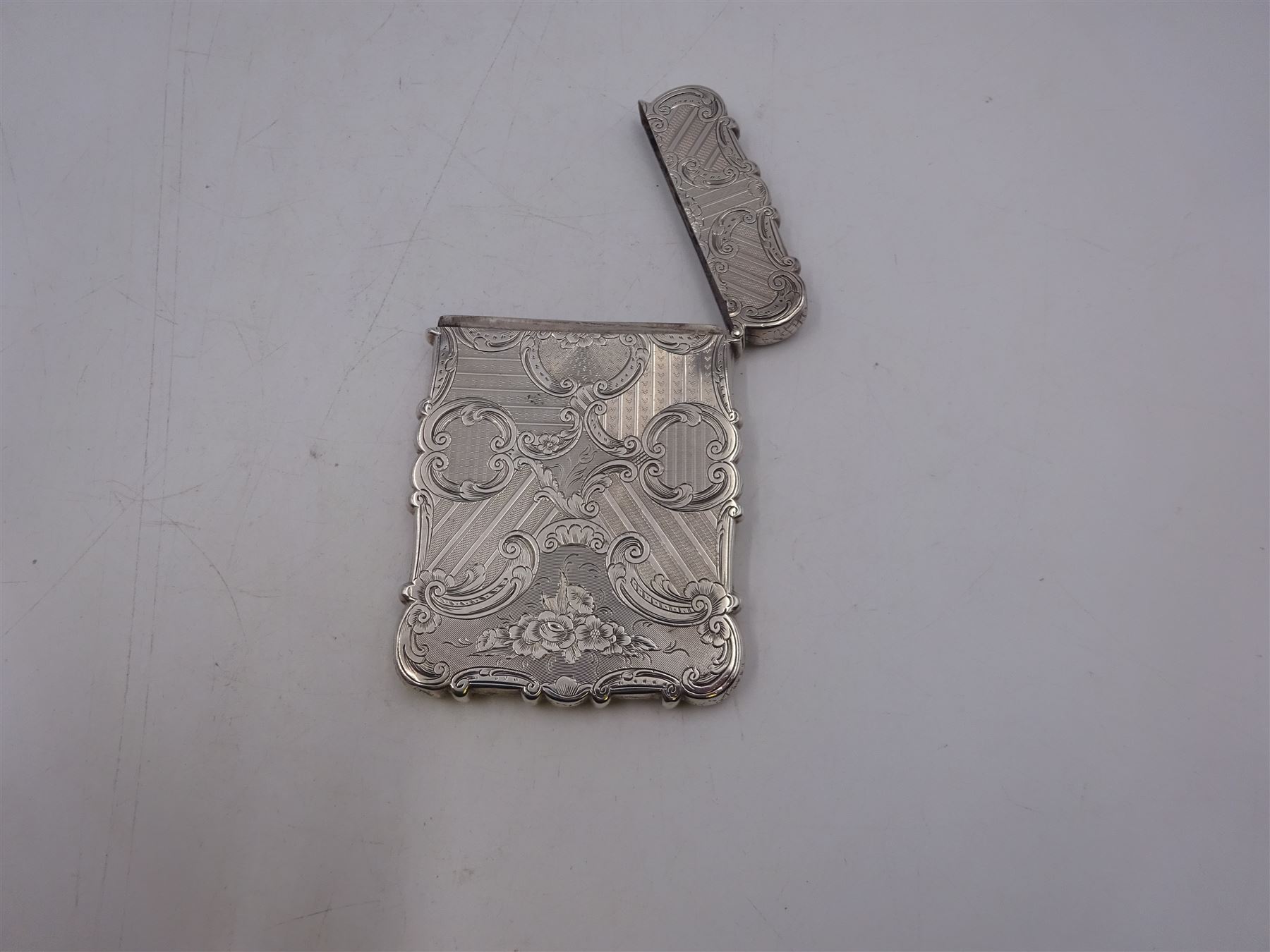 Victorian silver card case, of rectangular form with shaped edges, engine turned and floral decoration, with engraved hallmarked Nathaniel Mills, Birmingham 1845, H10cm